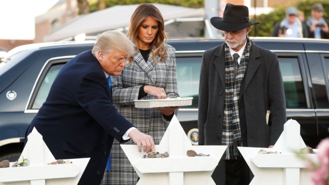 President Donald Trump places a stone as he stands with First Lady Melania Trump and Tree of Life Synagogue