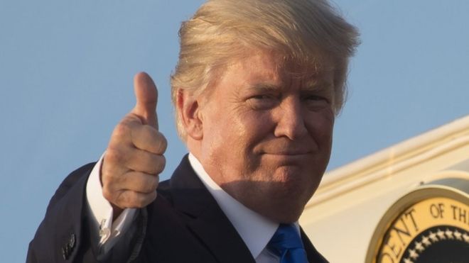 US President Donald Trump gives a thumbs-up as he boards Air Force One in Maryland on July 12, 2017.