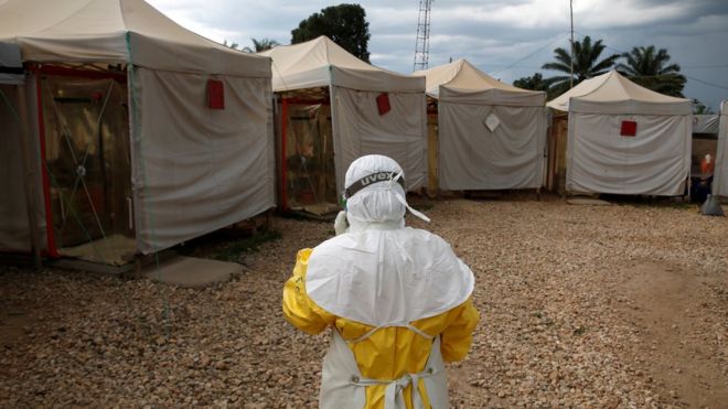 A medical worker wears Ebola protection gear