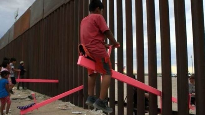أرجوحة على الحدود: أطفال يلعبون سويا على جانبي الجدار الفاصل