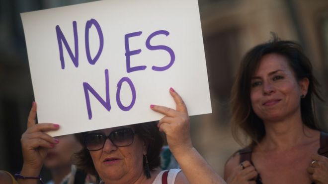 A woman holds a placard during a protest against sexual violence in Malaga, Spain, 21 June 2019