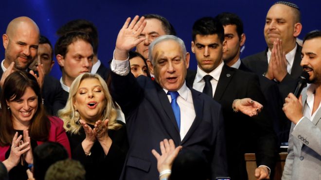 Israeli Prime Minister Benjamin Netanyahu waves to supporters at his Likud party's election headquarters on 3 March 2020
