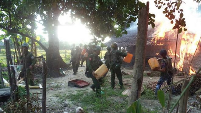 This handout photograph was released by the Myanmar Armed Forces on November 18, 2016, with information stating that Myanmar soldiers are putting out a fire in Wapeik village