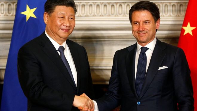 Italian Prime Minister Giuseppe Conte and Chinese President Xi Jinping shake hands after signing trade agreements at Villa Madama in Rome,