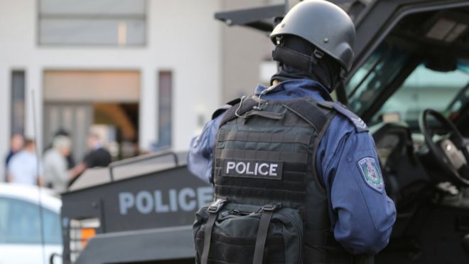 Тактический полицейский на месте рейдов на рассвете в среду в западной части Сиднея