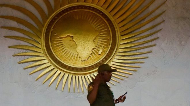 A security personnel stands by a sculpture representing the African continent, before the start of the 30th Ordinary Session of the Assembly of Heads of State and Government of the African Union (AU), in the entrance hall of the AU headquarters in Addis Ababa on January 27, 2018