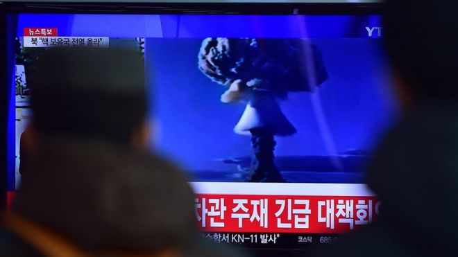 People watch a news report on North Korea's first hydrogen bomb test at a railroad station in Seoul on 6 January 2016