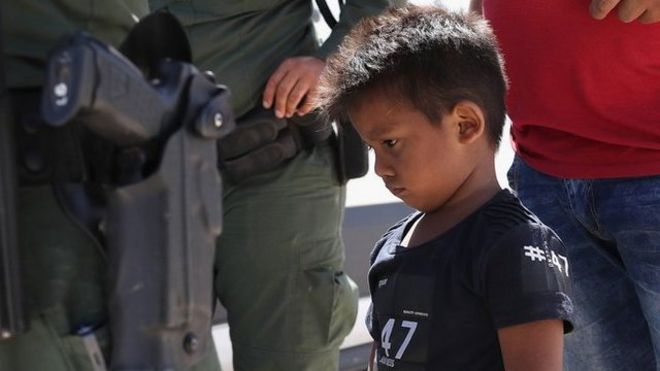 A small boy from Honduras waits as he and his father are taken into custody by U.S. Border Patrol agents near the U.S.-Mexico Border on June 12, 2018 near Mission, Texas.