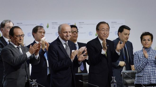 Participants in negotiating the climate deal applaud its agreement in Paris, 2015