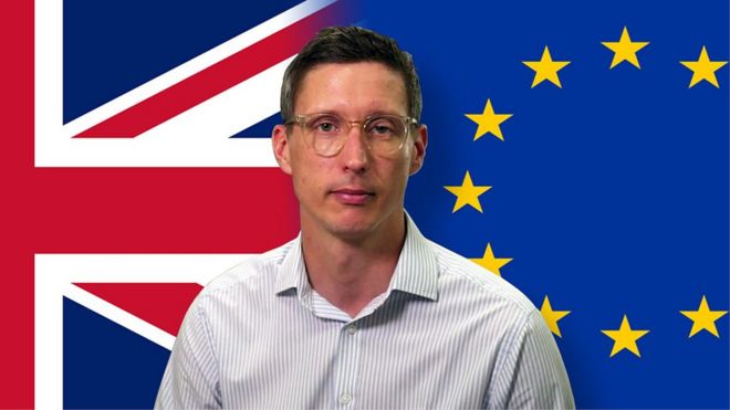 Jonathan Blake in front of UK and EU flags