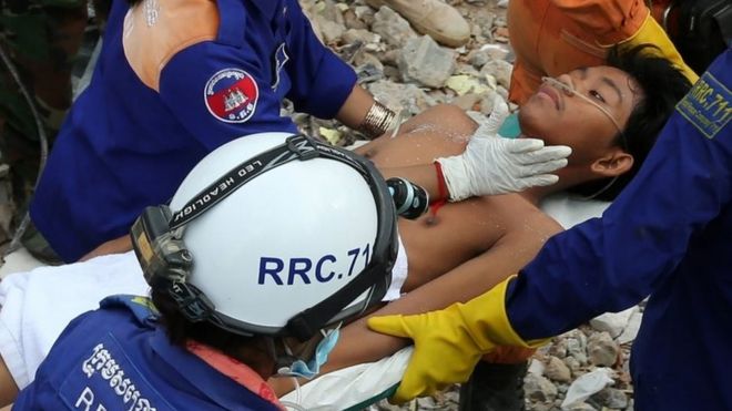 A survivor is carried on stretches after being pulled out of the rubble in Sihanoukville, Cambodia. Photo: 24 June 2019