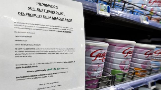A warning sign is posted in a supermarket in baby milk aisle