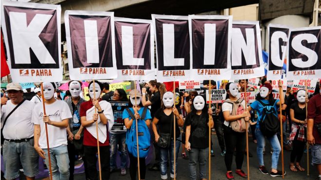 Filipino protesters hold placards reading 'killings' as they stage a demonstration to mark International Human Rights Day in Manila, Philippines, 10 December 2016.