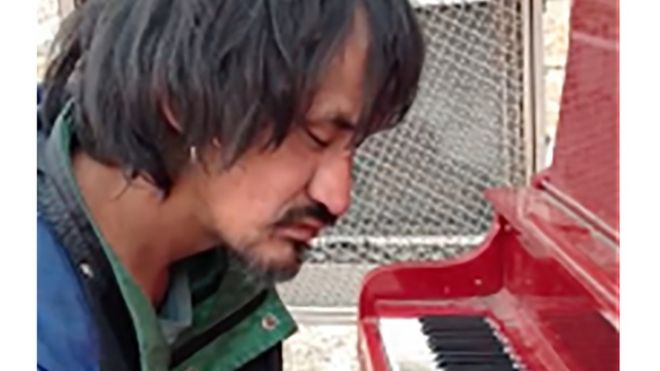 Ryan Arcand plays the piano in downtown Edmonton