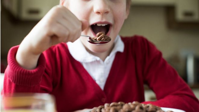 Child eating chocolate cereal