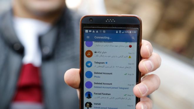 Мужчина из Ирана показывает свой мобильный телефон, пытающийся подключиться к каналам социальных сетей в Тегеране (2 января 2018 года)