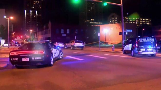 Police vehicles are seen at the scene of the shooting overnight
