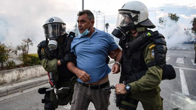 ОМОН задерживает демонстранта во время демонстрации в Салониках против соглашения, достигнутого Грецией и Македонией по разрешению спора по поводу названия бывшей югославской республики, 8 сентября 2018 года