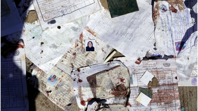 Blood stained voters' registration papers are seen on the ground at the scene of a suicide bomb attack that targeted a voter registration centre in Kabul, Afghanistan, 22 April 2018