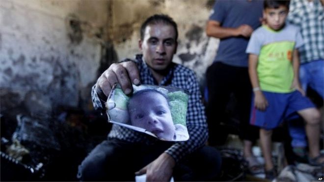 Палестинец держит обгоревшую фотографию Али Саада Давабши (31/07/15)