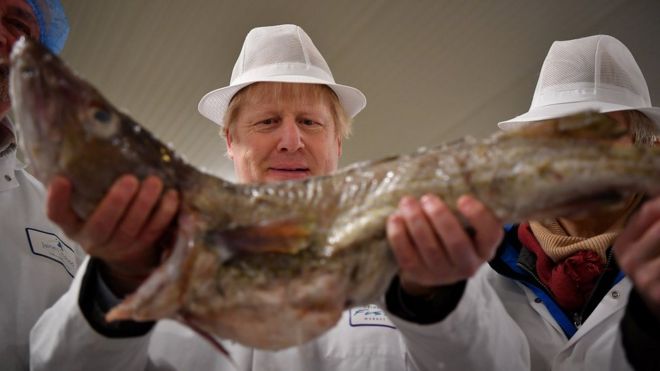 Boris Johnson holding a fish