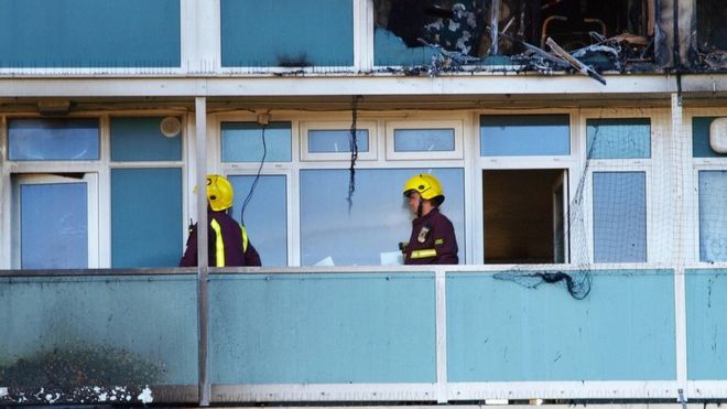 пожарные на балконе сгоревшей квартиры в доме Лаканала южного Лондона