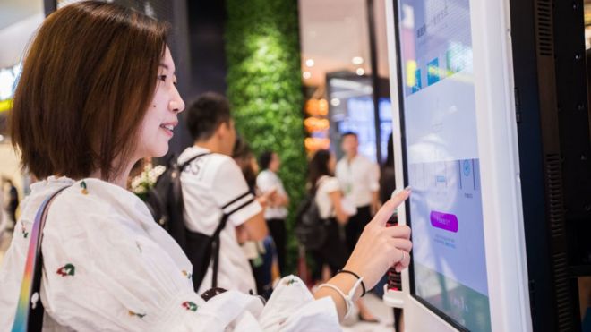 A customer purchases goods via Alipay which could collect money through recognizing customers' identity at KFC's KPRO restaurant on September 1, 2017 in Hangzhou