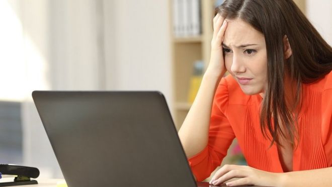 Stressed lady at computer