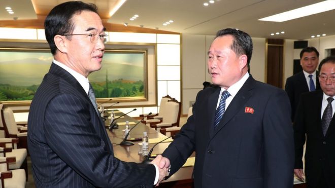 South Korean Unification Minister and chief delegate Cho Myoung-gyon (L) shakes hands with his North Korean counterpart Ri Son-gwon