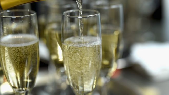 Champagne being poured into Champagne Flutes