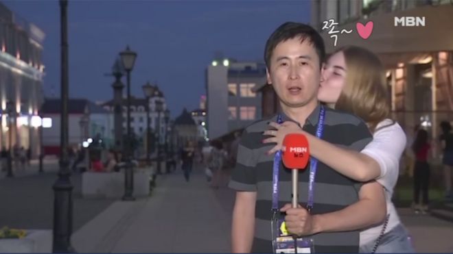 Jeon Gwang-ryeol being kissed by a jubilant Russian fan during live TV broadcast