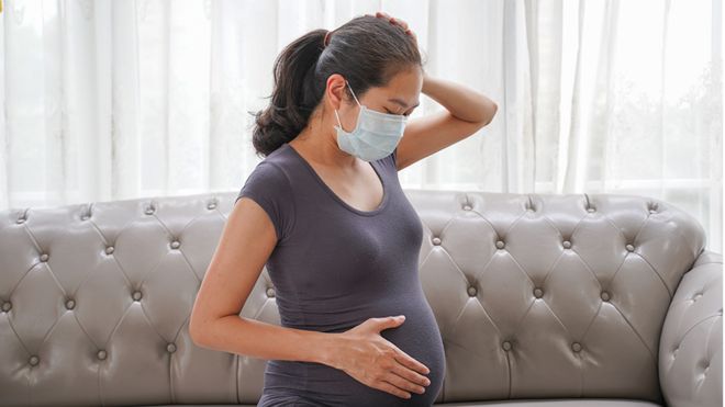 Pregnant woman wearing mask