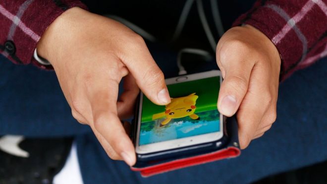 A close-up of someone playing Pokemon Go on their smartphone