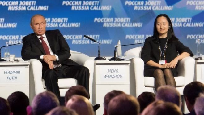 Russia"s President Vladimir Putin (L) and Meng Wanzhou, Executive Board Director of the Chinese technology giant Huawei, attend a session of the VTB Capital Investment Forum "Russia Calling!" in Moscow, Russia October 2, 2014
