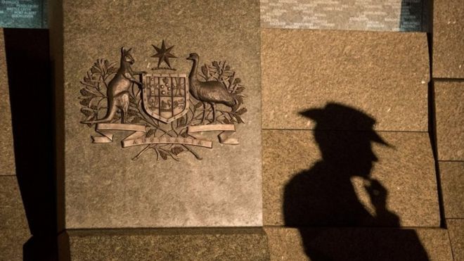 A silhouette of an Australian soldier standing in front of the Australian War Memorial in London