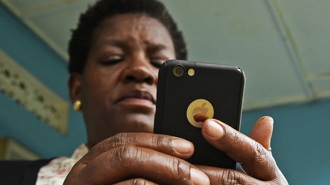 A woman on a mobile phone in Kampala, Uganda - 2018