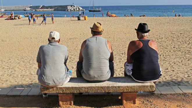 Men looking out at the sea in Spain