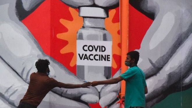 indian workers give final touches to a huge mural made on a wall outside the Tambaram railway station to promote awareness on the Covid-19 coronavirus disease vaccination in Chennai, India, 04 July 2021