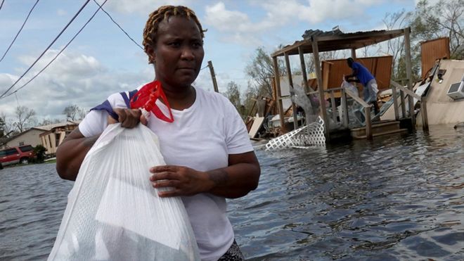 A woman rescues items from her homeafter it was destroyed by Hurricane Ida on 30 August 2021 in Laplace, Louisiana