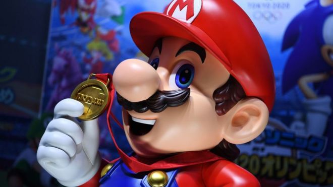 A real-world Mario statue holds a gold medal in this photo