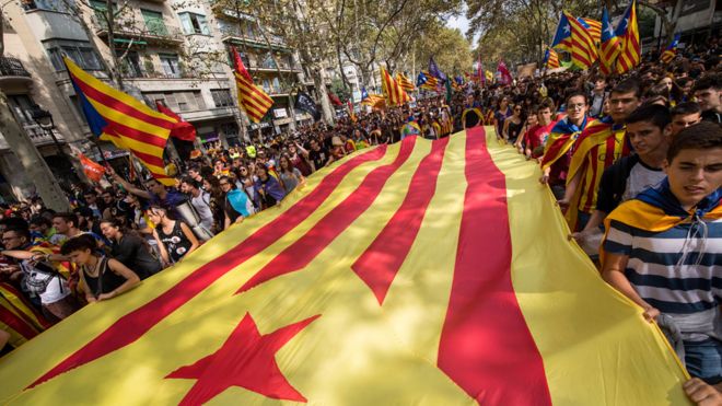 Students carry a big Catalan pro-independence flag during a university students strike on 28 September, 2017 in Barcelona
