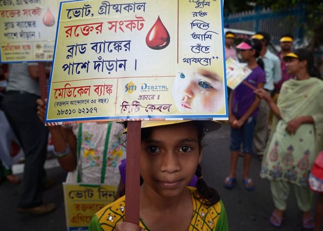 Индийские дети держат плакаты во время митинга в целях содействия сдаче крови в Калькутте 12 апреля 2015 года
