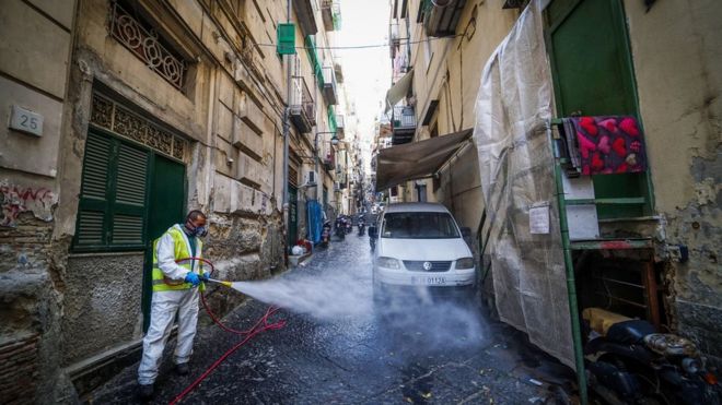 A worker disinfects the street at Quartieri Spagnoli, Naples, Italy, 18 March 2020