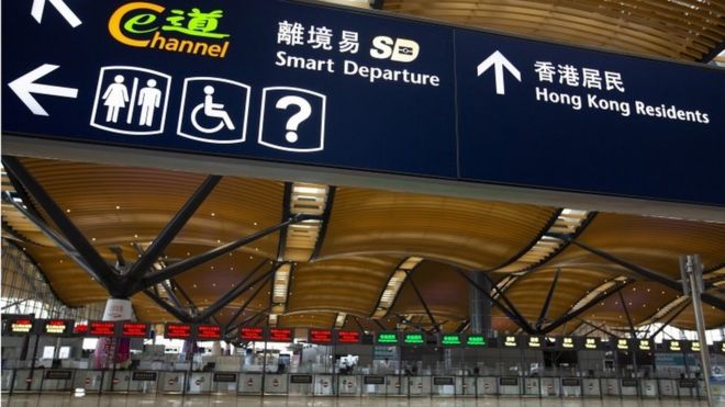 Signs in an empty immigration hall in Hong Kong