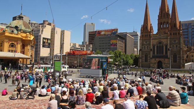 Толпа людей на площади Федерации в Мельбурне
