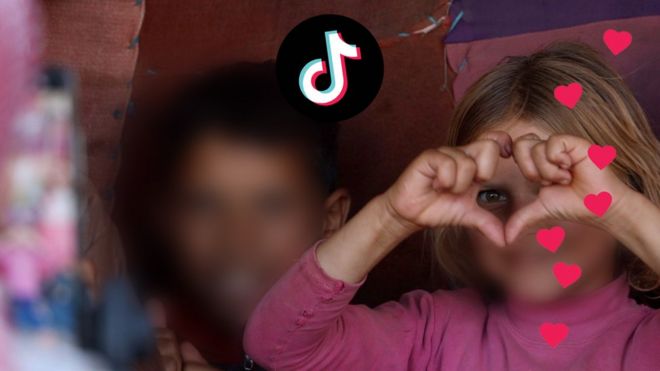 Girl makes heart symbol with hands, tiktok logo visible on the left