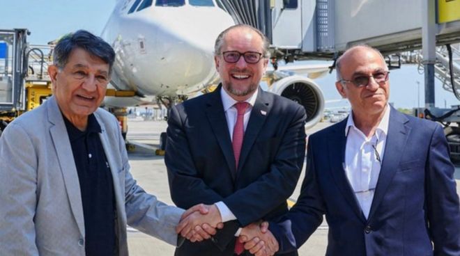 Kamran Ghaderi (right), and Massud Mossaheb (left) shake hands with Austrian Foreign Minister Alexander Schallenberg, at Vienna International Airport on 3 June