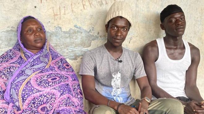 Doudou Diop sitting next to his mother and younger brother.