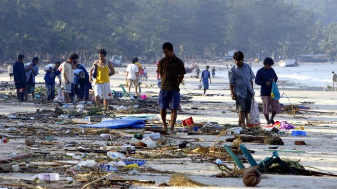 Sobreviventes andam pelos escombros da praia de Patong, em Phuket, no dia seguinte ao tsunami