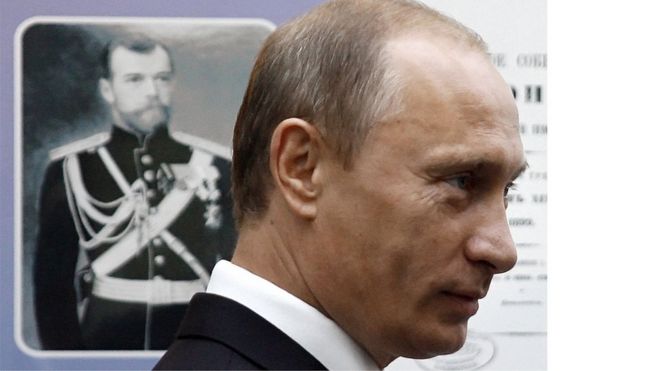 Russian President Vladimir Putin stands near a portrait of a Russian Tsar during a visit to a museum in Vladivostok in 2008.